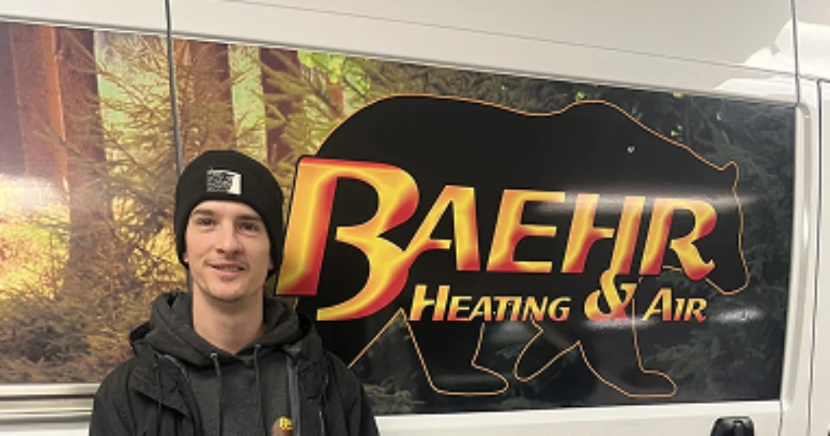 A Baehr Heating And Air technician standing in front of the company van in Grass Valley
